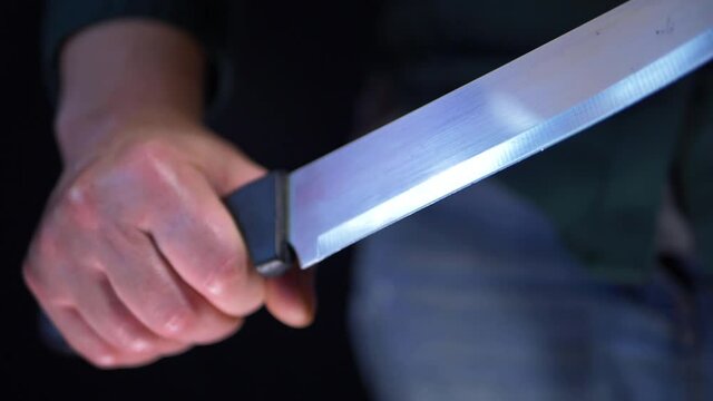 Violent criminal hands holding sharp knife