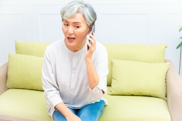 Senior asian woman holding Cell phone using mobile online apps.