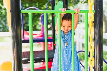 cute little girl laughing happily On the playground in the yellow sunlight happiness,
