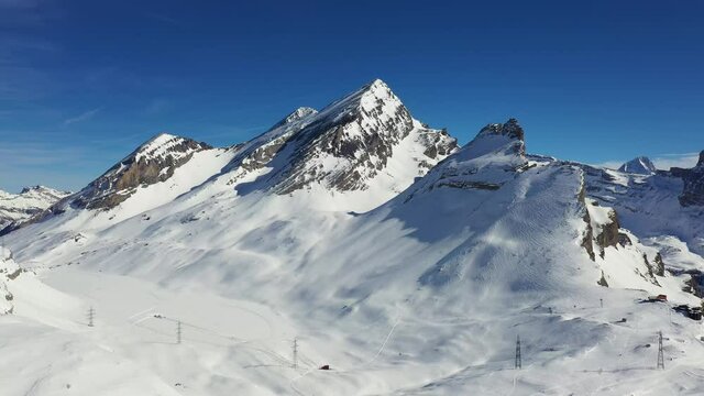 Aerial drone footage of the famous Gemmi pass in the alps in Canton Valais above the Leukerbad station on a sunny winter day in Switzerland. 