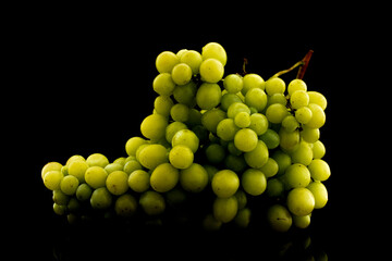 A bunch of sweet juicy grapes , close-up, isolated on black.