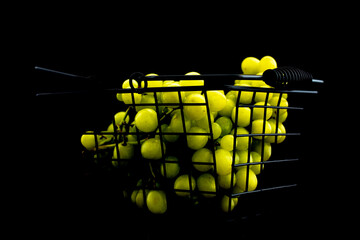 A bunch of sweet juicy grapes with a basket, close-up, isolated on black.