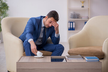 Young male employee waiting for business meeting