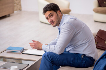 Fototapeta premium Young businessman employee waiting for business meeting