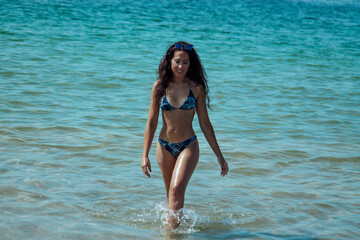 Woman in bikini coming out of the sea