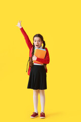 Emotional little school girl on color background