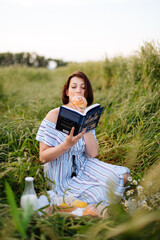 Beautiful young woman in summer in a wheat field