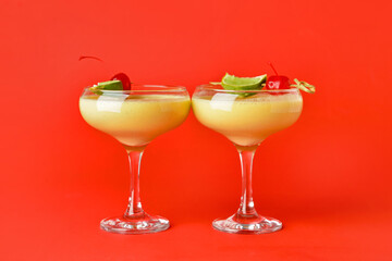 Glasses of tasty banana daiquiri cocktail on color background