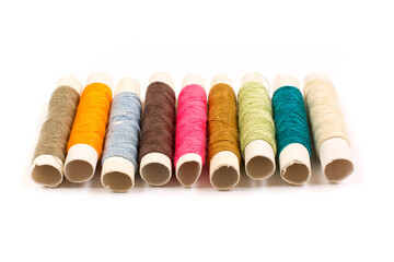 Colorful cotton yarns on rolls for sewing. Thread spools used in fabric and textile industry
