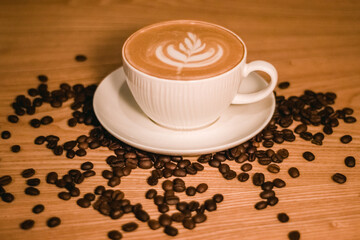 cup of coffee on a table with coffee bean 