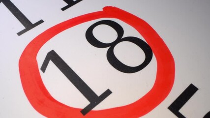 18 - Marking the date in the calendar with a red marker. The hand circles the date in the calendar with a pen