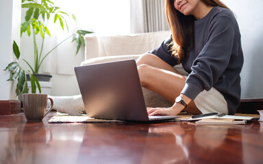 Fototapeta premium A young asian woman using and working on laptop computer at home