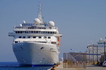 Modern white cruiseship cruise ship liner in port of Rhodes, Greece during summer Mediterranean...