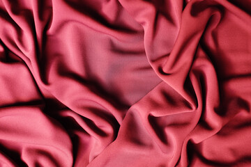 Smooth elegant red satin texture can use as abstract background. Luxurious background design. Closeup texture