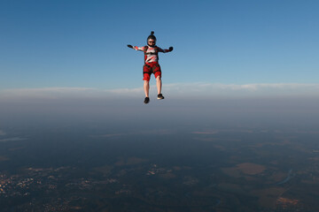 Skydiving. Freefly jump. A girl is having fun in the sky.