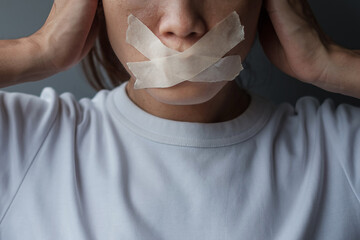 woman with mouth sealed in adhesive tape. Free of speech, freedom of press, Human rights, Protest...
