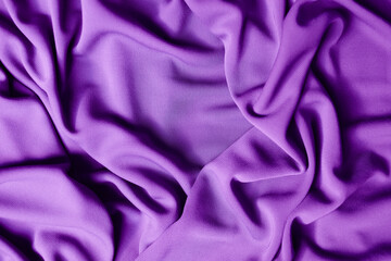 Smooth elegant violet satin texture can use as abstract background. Luxurious background design. Closeup purple texture