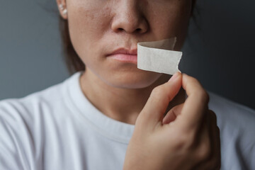 woman with mouth sealed in adhesive tape. Free of speech, freedom of press, Human rights, Protest dictatorship, democracy, liberty, equality and fraternity concepts - obrazy, fototapety, plakaty