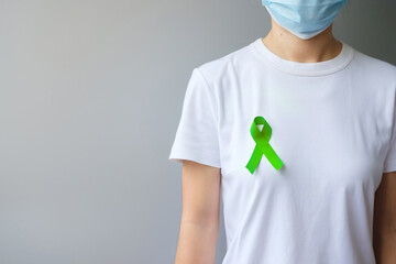 September World lymphoma and October Mental health day Awareness month, Woman with lime green Ribbon color for supporting people living, and illness. Healthcare concepts - obrazy, fototapety, plakaty