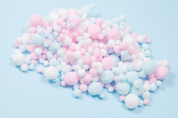 White, pink and blue soft pompons as a background.