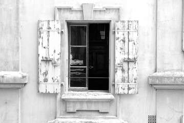 Open window with wooden white shutters at the old town of Lausanne on a beautiful sunny summer afternoon. Black and white photo taken July 29th, 2021, Lausanne, Switzerland.