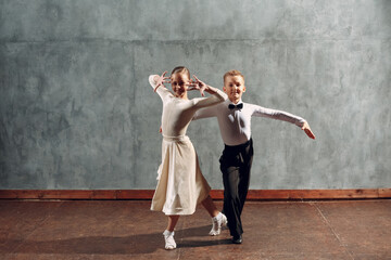 Young couple boy and girl dancing in ballroom dance Samba.
