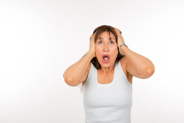 senior caucasian woman with hands on head screaming on white background