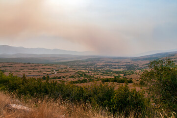 Smoke from a nearby fire hovered over the valley. On one of the trips through Herzegovina, I stopped to rest and came across this unusual sight of smoke falling on the valley.