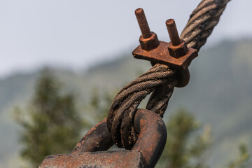 close-up of fastening the metal rope of the suspension bridge to the support