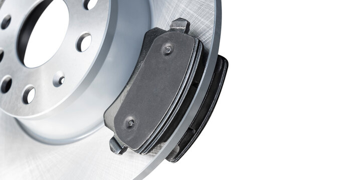 Brake discs and brake pads isolated on white background. Auto parts. Brake disc rotor isolated on white. Braking disk. Car part. Quality spare parts for car service or maintenance.