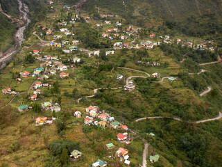 Fototapeta na wymiar An areal view of Lachung village as seen from the chopper top during monsoon, situated at 8000 ft altitude in North Sikkim. This is the most popular tourist destination of Sikkim.