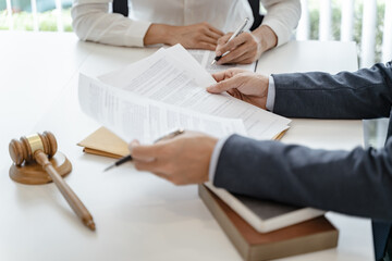 Legal counsel presents to the client a signed contract with gavel and legal law. justice and lawyer concept