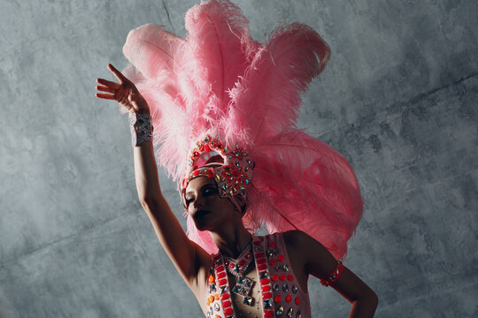 Woman in samba or lambada costume with pink feathers plumage.