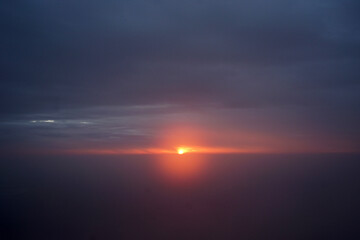 Naklejka na ściany i meble Sunrising at dawn time with foggy and cloudy blue sky