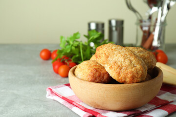 Concept of tasty food with cutlets on gray textured table