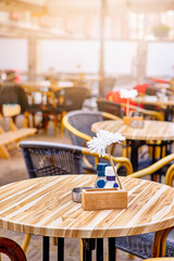 Traveling Through The Netherlands. Comfortable and Relaxing Open Air Restaurant With Variety of Tables and Camomile In Small Dutch City.