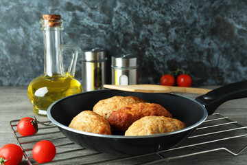 Concept of tasty food with cutlets on gray textured table
