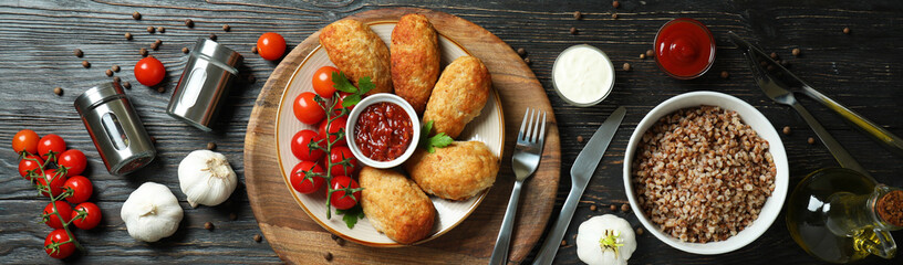 Concept of tasty food with cutlets on wooden table