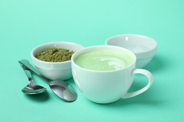 Fototapeta na wymiar Cup of matcha latte and accessories for making on mint background