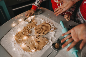 mom and daughter bake christmas gingerbread cookies