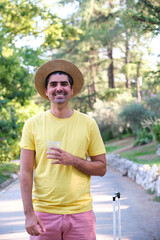 Obraz premium Tourist drinking a refreshment, standing and looking at camera.