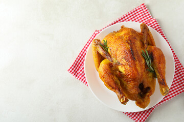 Plate with roast turkey on white textured table