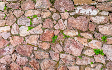 stone wall with some green moss, seamless natural background