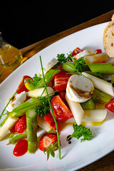 Asparagus salad with strawberries, tomatoes and goat cheese