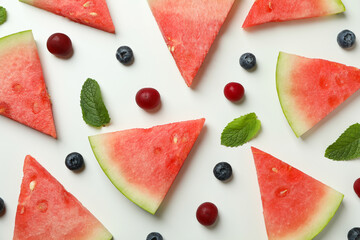 Flat lay with watermelon slices and berries on white background