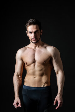 Portrait of an attractive muscular man on a dark background