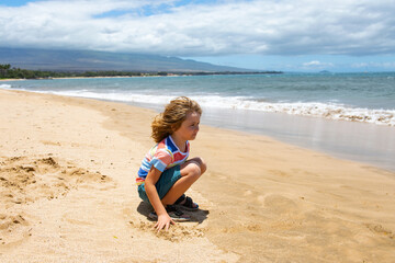 Fototapeta na wymiar Cute baby boy playing with sand on summer tropical beach.
