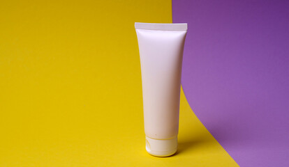 packaging of face or hand cream on colored background