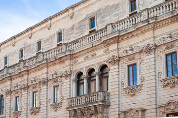 Fototapeta na wymiar exquisite baroque work leccese exterior of the facades of the palazzo del seminario, emphasis on the rich framing of columns and balusters of the balcony of the museum