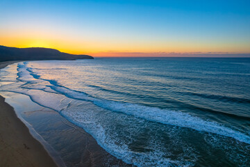 Aerial sunrise over the sea with clear skies